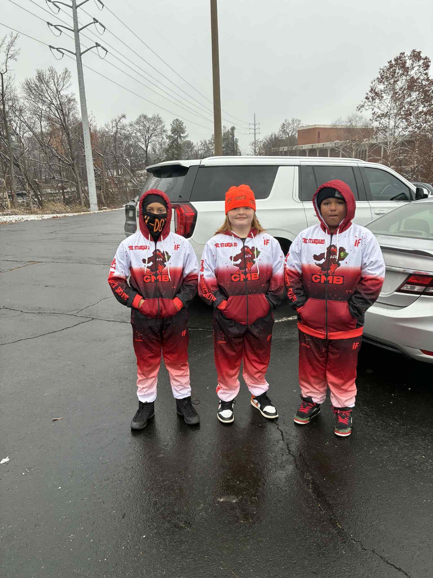 GMB players in matching red fade custom zip-ups and joggers